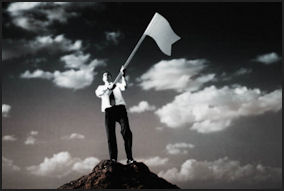 long-term-goals-business-man-waving-white-flag